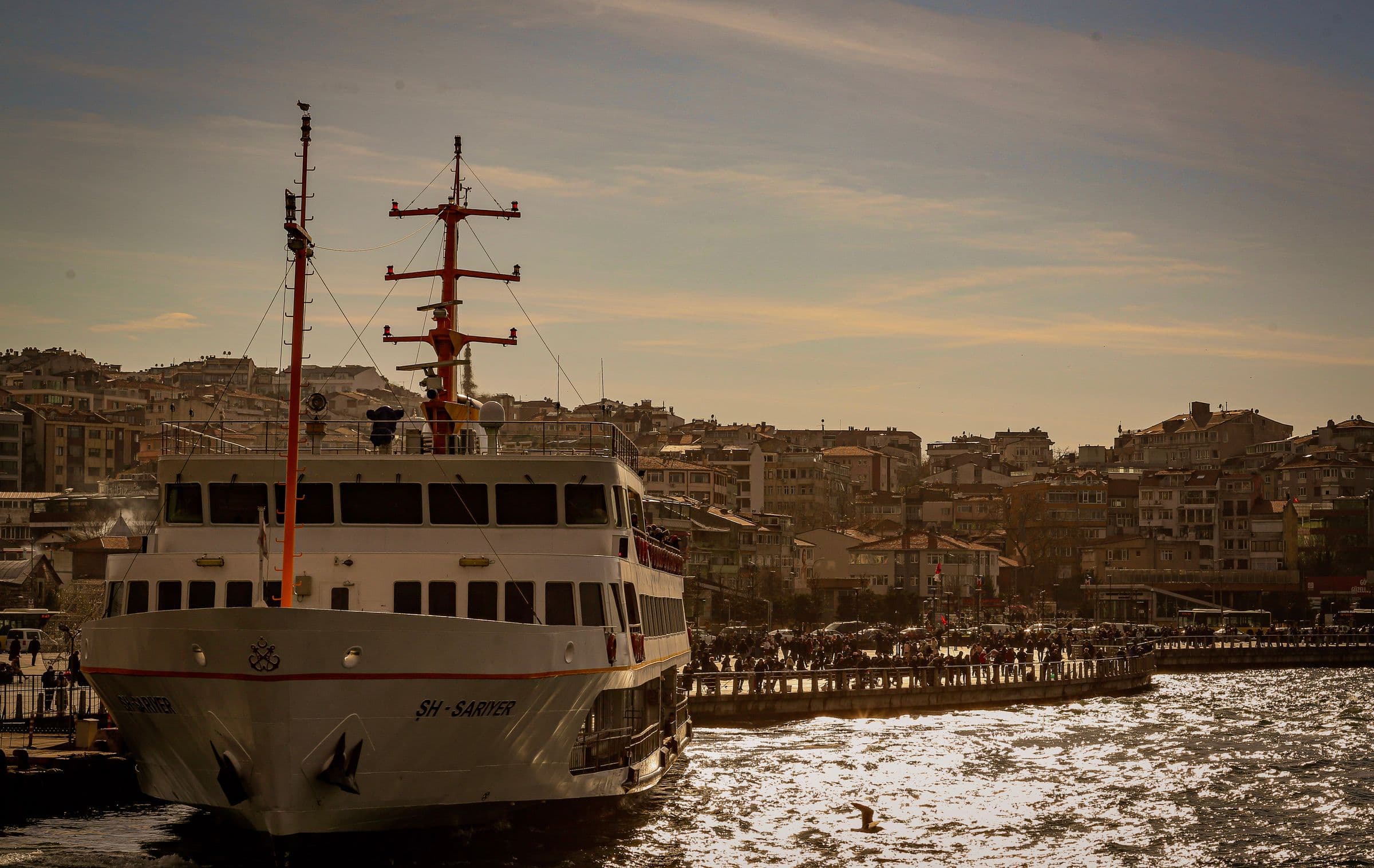 A Bosphorus ferry passing the Istanbul skyline at golden hour